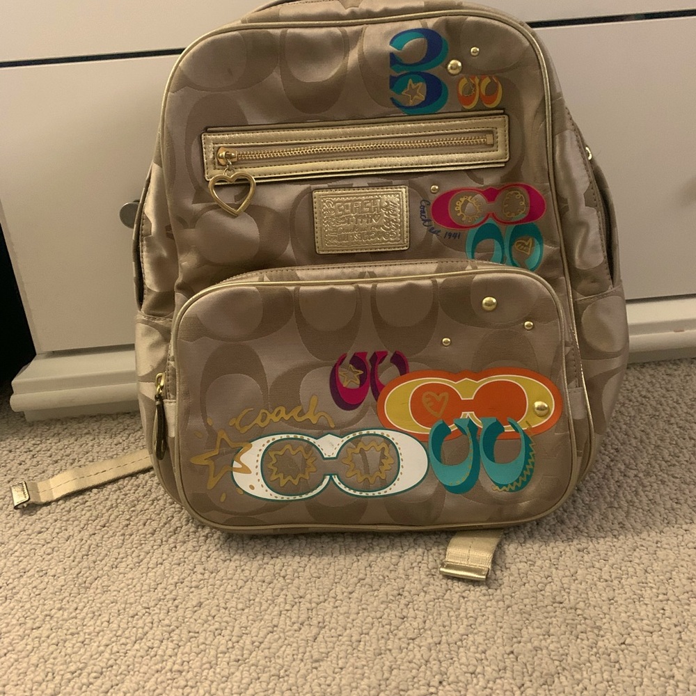 Gold toned Coach backpack.  Used only one time, in excellent condition!